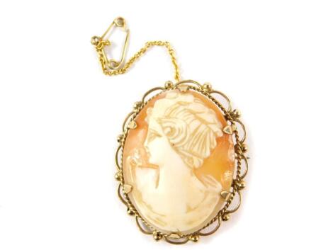 A 9ct gold and shell cameo brooch, bust portrait of a lady, with safety chain as fitted.