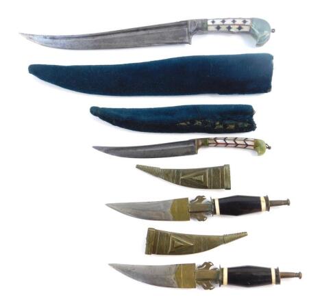 An Indo Persian dagger, with single edge steel blade, mother of pearl and jade set handle, with a green velvet bound sheath, 34cm W, a similar small knife, 21cm W, and a pair of Middle Eastern knives, with wooden and bone handles, brass sheaths with stipp