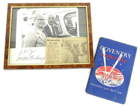 A photograph of two German airmen returning to the city of Coventry to commemorate the 40th Anniversary of the raid, comprising of press photograph, press clipping and signatures of Heurgunta Unger and Heur Lukesh Diether, also Coventry Under Fire by the 