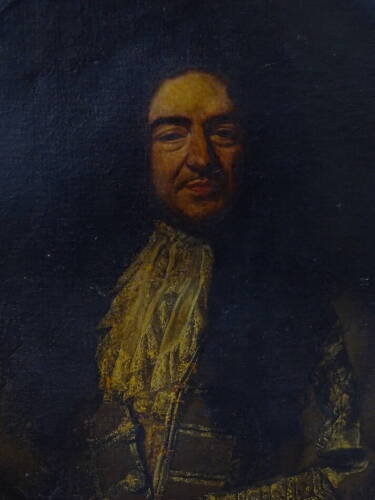 18thC School. Half length portrait of a gentleman in green jacket, lace collar and wig, holding a letter, oil on canvas, 103cm x 91cm.