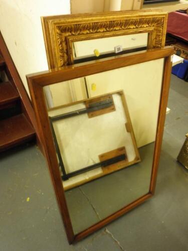 A rectangular gilt wall mirror with a carved border