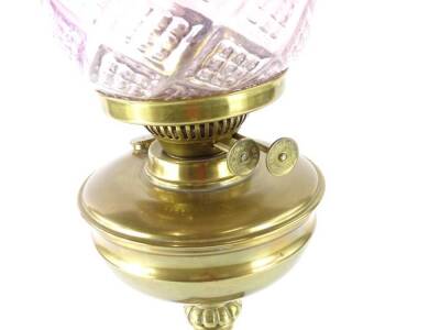 A Victorian brass oil lamp, with cranberry tinted moulded glass shade, the base with reeded column and wooden plinth, 60cm H overall. - 2