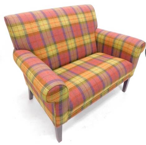 A two seat sofa, upholstered in Dorma pink, purple, yellow and green Berwick pattern tartan fabric, on square tapering legs, 124cm W, and a loose cushion.