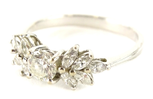 An 18ct white gold diamond cluster ring, with central round brilliant cut diamond approx 0.38cts, flanked by five pear cut diamonds to each shoulder, on three row design band, stamped 750, ring size P½, 2.9g all in.