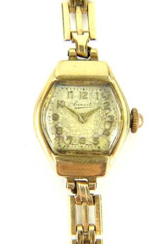 An Everite ladies wristwatch, with small oval dial, in a yellow metal casing, unmarked, on a gold plated strap.