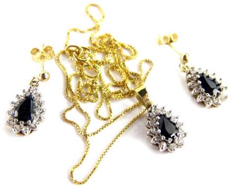 A 9ct gold necklace and earring set, with pear shaped pendant and earring drops, each with central set sapphire, surrounded by white stones, the necklace on a fine link chain, the earrings with butterfly backs, the pendant 1cm x 0.8cm, 3.6g all in.