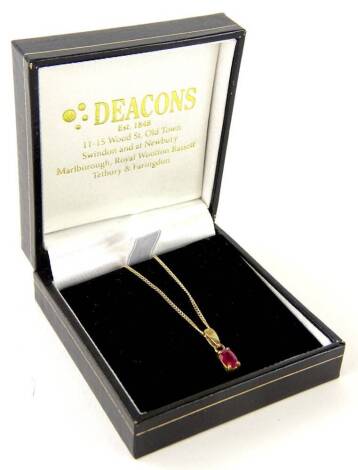 A 9ct gold garnet pendant and chain, with oval cut garnet, in four claw setting, on a fine link chain, 2.4g all in, boxed.