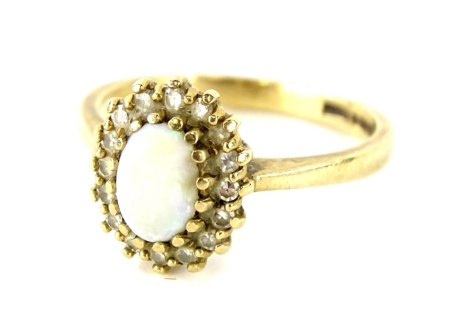 A 9ct gold opal and diamond dress ring, with oval cut opal (AF), surrounded by sixteen white stones, each in claw setting, ring size N ½, 2.8g all in.