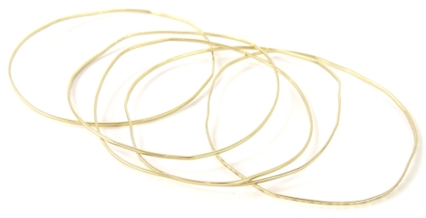 Five thin bangles, each of varying design, two marked 333 Gal, rest unmarked, believed to be yellow metal.