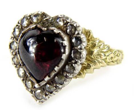 A heart shaped garnet and diamond ring, with a cabachon garnet in a surround of old cut diamonds, set in white and yellow metal, possibly two parts joined, size Q, 5.6g.