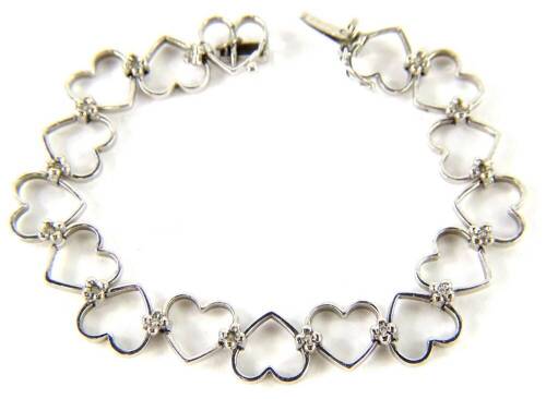 An 18ct white gold heart shaped bracelet, with various heart links, joined with tiny diamonds, 18cm L overall, 14.7g all in.