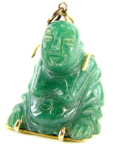 A carved jade Buddha pendant, with yellow metal wire frame, with Chinese writing to the rear, stamped 14k, 2.5cm H, 7.9g all in.