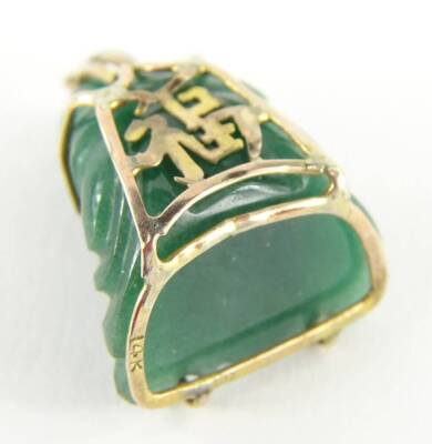 A carved jade Buddha pendant, with yellow metal wire frame, with Chinese writing to the rear, stamped 14k, 2.5cm H, 7.9g all in. - 2