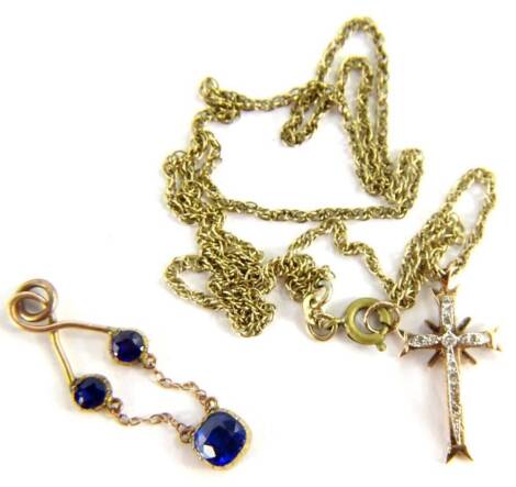 Two pendant and a chain, to include a diamond set crucifix pendant, in yellow metal setting, unmarked on a fancy link chain, marked 9ct, with later gold plated clasp and joining link, and a yellow metal pendant, set with three blue stones, 7.7g all in.