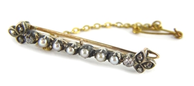 A Victorian bar brooch, set with six seed pearls to the central and single diamond to each end, with three section marcasite set end, in yellow metal frame, unmarked with safety chain, boxed, 4cm W, 3.8g all in.