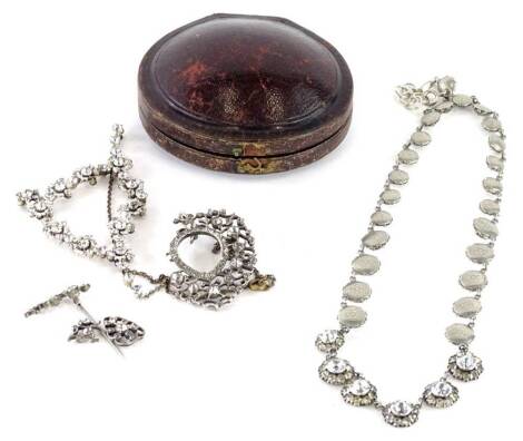 Various Edwardian and other jewellery, comprising a graduated cluster necklace, set with white paste stones, in silver plated and engraved mounts, a modern floral necklace, with cluster formed in a triangle on silver plated chain, and an oval locket/brooc