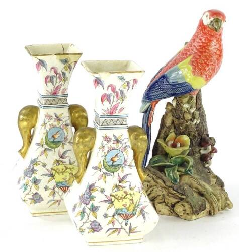 An oriental porcelain figure of a parrot, seated on a branch, impressed marks to underside, stamped MING JUI, and a pair of English pottery aesthetic style vases, decorated with fans, oriental figures, birds, etc. (AF)