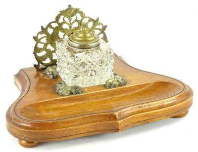 A continental walnut inkstand, with a pierced letter compartment, a cut glass inkwell and a dished area for pens, 23cm W.