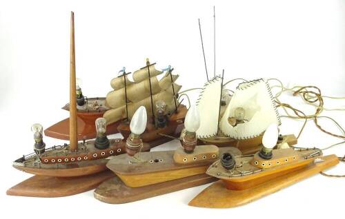 Various carved wooden boat shaped lamp bases, each with batique type sails.