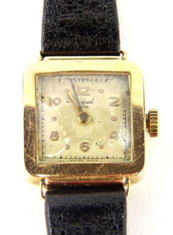 A Phiegied Extra ladies wristwatch, with small square watch head, with cream coloured dial, partially rubbed, marked 18K, on a later thin black leather strap.