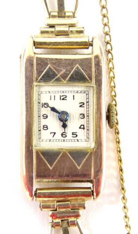 An Art Deco 9ct gold ladies wristwatch, with square dial, on white ceramic back, with blue hands, on a rolled gold strap, 12.7g all in.