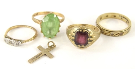 Four 9ct gold dress rings and a crucifix pendant, comprising a garnet set signet ring, (AF), a 9ct and plat dress ring, a cz eternity ring, a pale green stone dress ring, and a small crucifix, 11.2g all in.