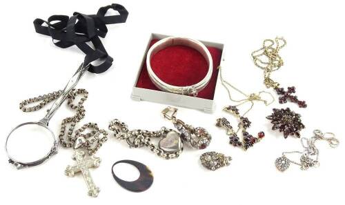A quantity of vintage silver and other costume jewellery, to include a silver heart shaped bird bar brooch, a silver crucifix pendant on fancy link chain, a mother of pearl and marcasite handled magnifying glass, on ribbon banding, a silver hinged bangle,