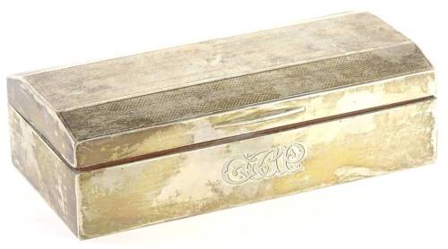 A George V Art Deco silver cigarette box, the hinged lid with engine turned herring bone type design enclosing a cedar lined interior, engraved monogram to front, loaded, Birmingham 1930, 18cm W.