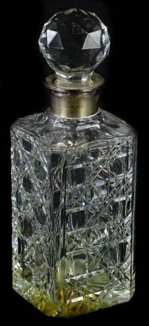 A cut glass square section decanter and stopper, with silver collar and hallmarked for London 1977, 27cm H.