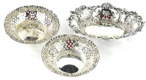 A late Victorian pierced silver bon bon dish, decorated with birds, etc., (AF), Birmingham 1899, 2oz, and a pair of similar silver plated bon bon dishes. (3)