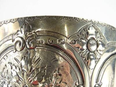 A Victorian silver goblet, with embossed decoration of flowers and leaves within oval cartouches, engraving Darlington Steeple chase ¾ mile J Kay 1875, marks indistinct, Birmingham assay, possible George Unite, 7¼oz, 19cm H. - 2