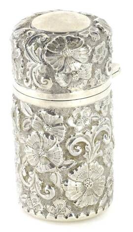 An Edwardian silver cased and brass scent bottle, the hinged lid and base with embossed flower decoration, Chester 1901, 7.5cm H.