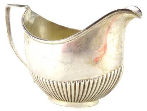 An Edwardian silver milk jug, with part fluted decoration, Birmingham 1907, 2¾oz.