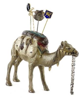 A cold painted model of a pin cushion, modelled in the form of a camel, stamped to the underside Geschutz and four stick pins.