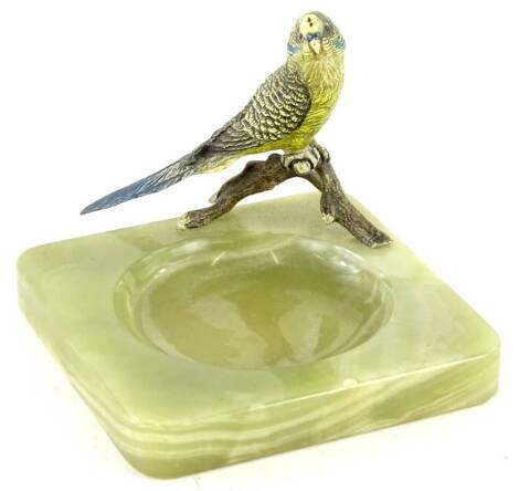 A cold painted bronze figure of a budgerigar, mounted on an onyx ashtray base, 12cm W.