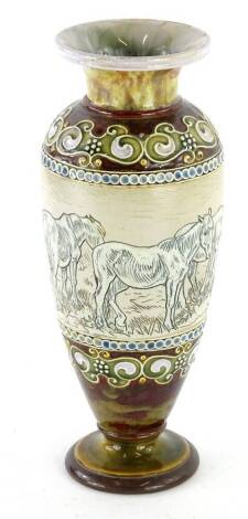 A Doulton Lambeth stoneware vase, with incised decoration of horses by Hannah Barlow, within foliate and beaded borders, in brown, turquoise and navy blue, impressed mark to underside and decorators monogram, 29cm H.