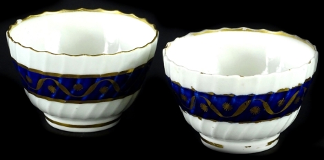 A pair of early 19thC Caughley porcelain tea bowls, each with a cobalt blue brown band picked out in gilt. (AF)