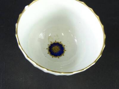 A pair of early 19thC Caughley porcelain tea bowls, each with a cobalt blue brown band picked out in gilt. (AF) - 2