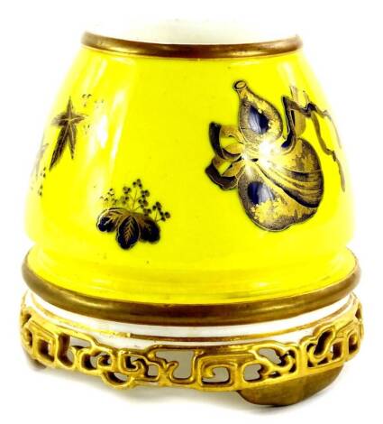 A Royal Worcester oriental style vase, decorated with fans, vessels, etc., in gilt cobalt blue on a yellow ground, with a pierced base, printed mark in blue to underside, 12cm H.