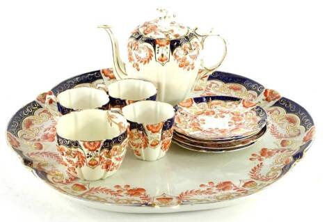 An early 20thC Aynsley porcelain cabaret set, decorated in Imari pattern, to include teapot, cups, saucers and a tray, 37cm dia.