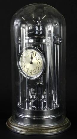 A chrome plated anniversary type clock, with a dome top, paper dial with Arabic numerals, housed within a glass dome, on a chrome plated base, 45cm H.