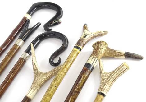 A collection of shepherd's crooks, etc., to include examples with horn and antler handles, silver collars, etc.