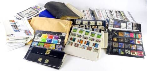 A large quantity of presentation packs, First Day covers, stamps, etc. (2 boxes)