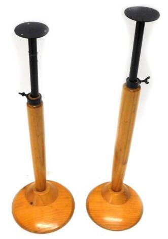 A pair of pine and ebonised metal mannequin stands, 55cm at its lowest.