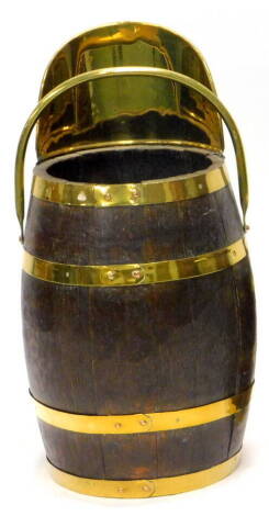 A coopered oak and brass coal scuttle, with swing handle, 57cm H.