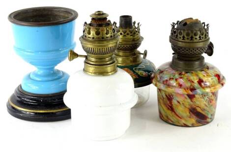 A collection of oil lamp fittings, to include an Art Nouveau style ceramic and glass reservoir, a mottled glass and opaque glass example and a lamp base in turquoise coloured glass.