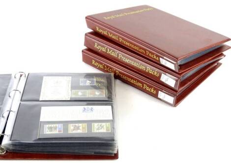 Four albums of presentation stamp packs, various subjects.