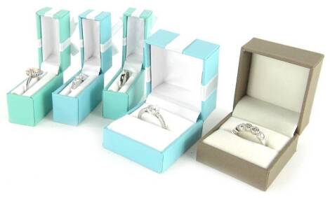 Five silver dress rings, to include a plain silver band and four stone set dress rings, each set with CZ stones, boxed. (5)