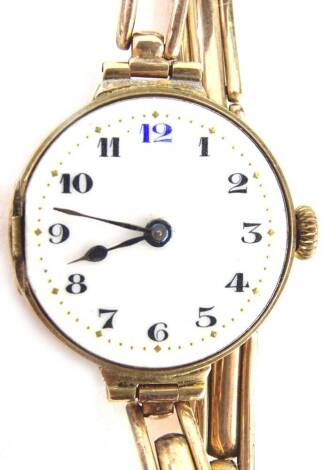 A 9ct gold wristwatch, with a circular white enamel dial, in gold casing, lacking glass, on an expanding gold bracelet, 19.8g all in.