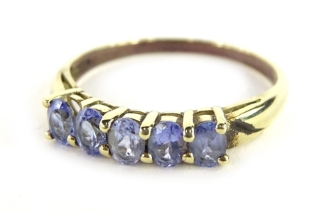 A 9ct gold dress ring, set with five oval cut pale purple/blue stones, each in claw setting, ring size P, 1.9g all in.